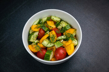Delicious salads on a dark table
