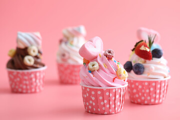 Colorful cupcakes isolated in pink background