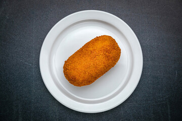 Chicken Kiev Cutlets on a dark table
