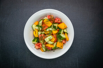 Delicious salads on a dark table

