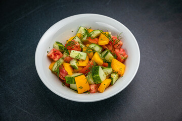 Delicious salads on a dark table

