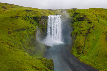 Fototapeta na wymiar Iceland. Aerial view on the Skogafoss waterfall. Landscape in the Iceland from air. Famous place in Iceland. Landscape from drone. Travel concept