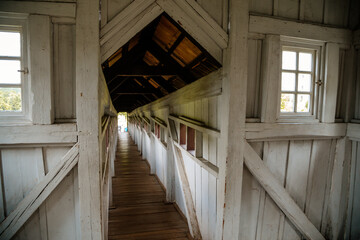 Fototapeta premium Wonderful covered wooden bridge by Dusan Jurkovic in garden, arcade, white walls with small windows, renaissance chateau castle Nove mesto nad Metuji, Eastern Bohemia, Czech Republic