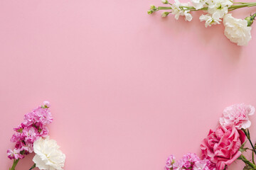 Mothers day and holiday design concept - top view of carnation and roses on pink background banner for mothers day, wedding and valentines day with copy space for mock