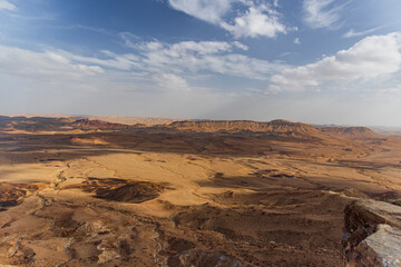 Fototapeta premium Ramon Crater Makhtesh Ramon, the largest in the world, as seen from the high rocky cliff edge surrounding it from the north, Ramon Nature reserve, Mitzpe Ramon, Negev desert, Israel. High quality