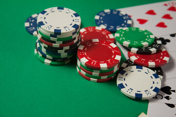 Classic playing cards, chips, red dice and dollars on green background. Gambling and casino concept.