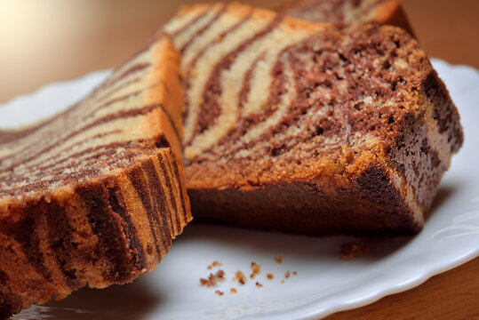 Delicious pieces of Marble Cake, Tiger cake on white plate