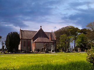 Fototapeta na wymiar Rural church and cemetery in Fenor