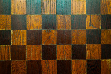 An old wooden chessboard without pieces.