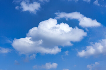 Obraz na płótnie Canvas White cumulus clouds on blue sky background, natural phenomenon