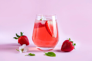 Still life with glass of cooling strawberry Sangria with sparkling wine, strawberry, ice cubes. Refreshing summer alcoholic cocktail drink , lemonade or ice tea. Copy space for text.