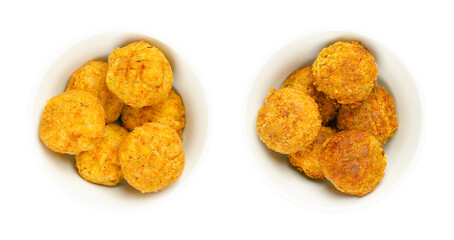 Vegan falafel balls, pre-fried and deep-fried in white bowls. Groups of ball shaped fritters, based on chickpeas, a traditional Middle Eastern food. Convenience food. Close-up, from above, food photo.
