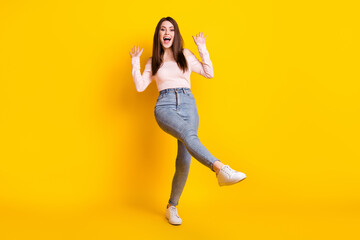 Fototapeta na wymiar Full size photo of young beautiful funky funny cheerful excited amazed woman dancing isolated on yellow color background