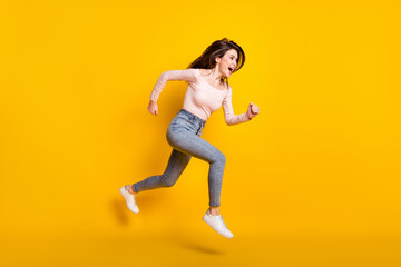Fototapeta na wymiar Full size profile side photo of young happy excited girl look copyspace running in air isolated on yellow color background