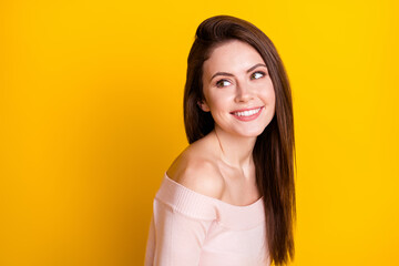 Fototapeta premium Photo of charming cute young woman dressed off-shoulders sweater smiling looking back empty space isolated yellow color background