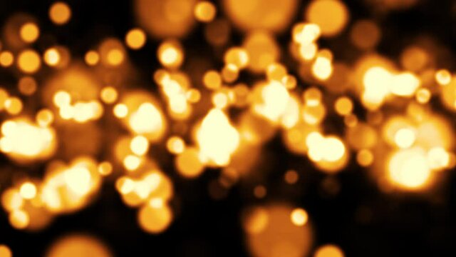 Gold dust particles fly in slow motion in the air lingering slowly. Dust Particles Background Bokeh Lights Background on Black Background 4k Footage in 1000fps resolutions.
