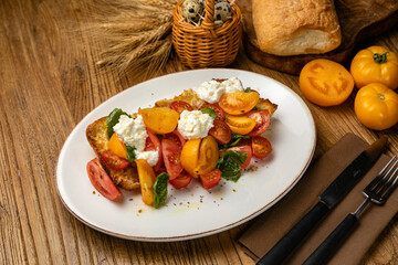 Salmon, cheese, tomatoes on croutons on a wooden table
