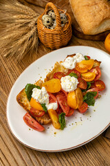 Salmon, cheese, tomatoes on croutons on a wooden table
