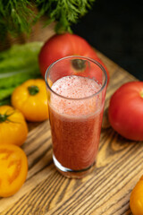 Tomato juice, on a children's table, near the green and yellow and red tomatoes
