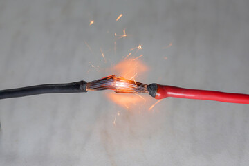 short circuit of electrical wiring sparks molten wires selective focus