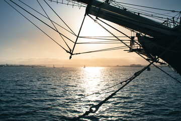 Sunset behind the silhouette of a sailboat in San Diego