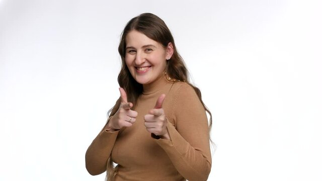 Portrait of happy smiling woman showing gotcha sign with hands. Concept of victory, winning and success