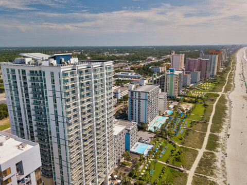 Aerial image of Ocean front hotels and hi-rise apartments and condominiums in Myrtle Beach South Carolina looking north over the warm sunny beach