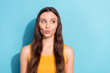 Fototapeta premium Photo portrait woman in yellow clothes sending air kiss looking copyspace isolated pastel blue color background