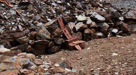 Too many rocks and a little bricks lying on the ground