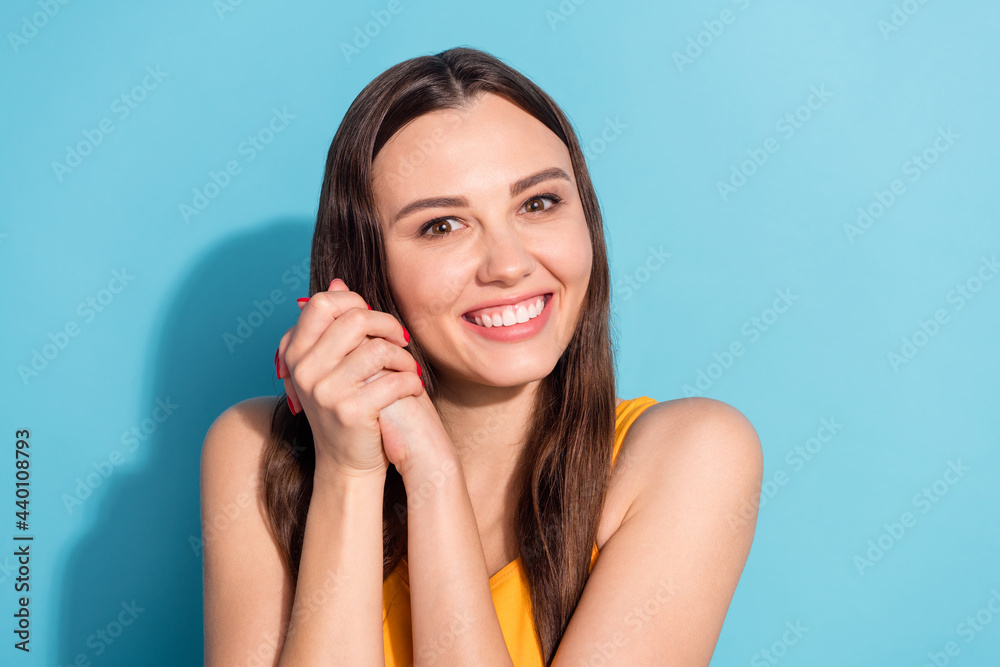 Poster Photo portrait girl keeping hands together smiling cute in casual clothes isolated pastel blue color background