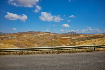 road between the landscape of central sicily in full summer