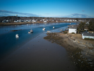Fototapeta na wymiar Aerial drone image of moored lobster boats in the deeper channel at low tide on the Maine Coast