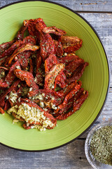dried tomatoes dressed with garlic, oregano and oil.