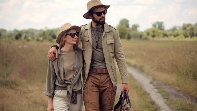 Couple On Safari Clothes Style.Inspiration Travel On Africa.Stylish Outfit On Wildlife Landscape.Tourist Trendy Look On Vacation Trip.Happiness Scenic Fashion Model.Summer Adventure On Africa Reserve.