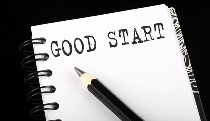 GOOD START written text in small notebook on a black background