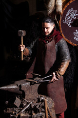 Fototapeta na wymiar Viking forge weapon sword man warrior clothe fire