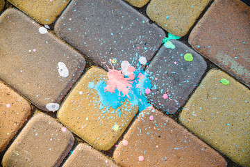 colored blot of paint on paving slabs. yellow paving stones