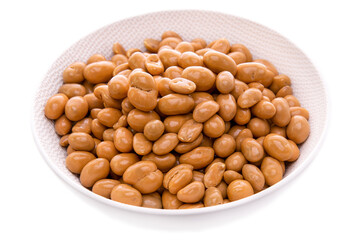 groundnut in caramel glaze in a white dish on a white background . Isolated items and products.