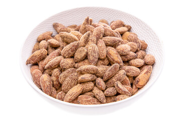 almond kernels, salted nuts in a white dish on a white background . Isolated items and products.