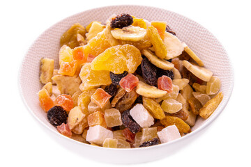 a mixture of chopped dried fruits and berries, nuts in a white dish on a white background . Isolated items and products.