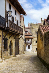 Fototapeta na wymiar Narrow alley of old town in northern Spain with stone houses. Santillana del Mar.