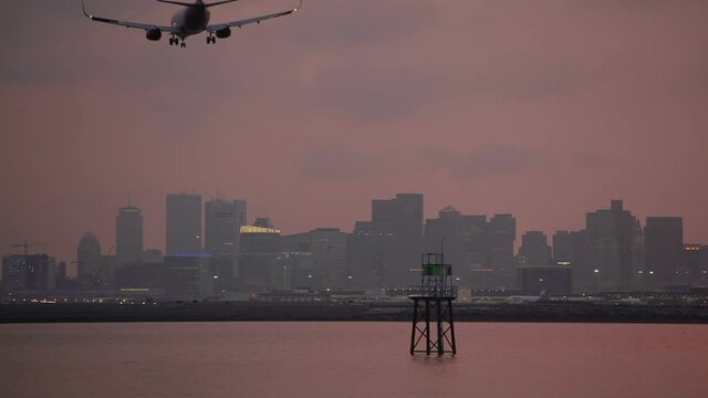 boston harbor plane landing on left dusk