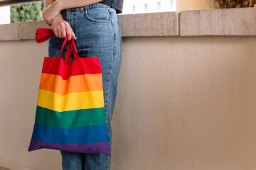 close up of young woman with rainbow LGBT shopping bag