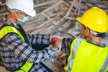 Physical injury at work of construction worker. Injury bleeding from work accident in pile of...