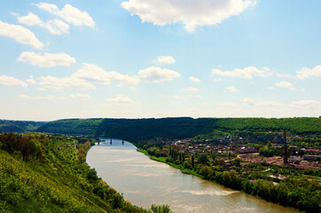 Picturesque spring aerial landscape view of canyon and Dnister River in the Zalishchyky town. Ternopil region, Ukraine. Blue sky background. Nature and travel concept