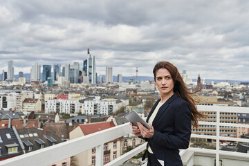 Mid adult female entrepreneur looking away while standing on rooftop