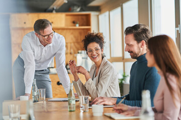 Businessman looking at colleagues in meeting at office