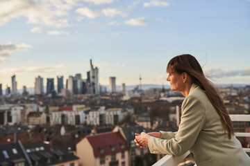 Businesswoman looking at view while standing on rooftop