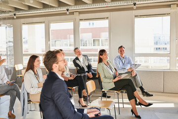 Male and female colleagues attending educational training class at office