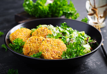 Homemade fish croquettes from white fish in cornflakes breading. Fritters from minced cod....